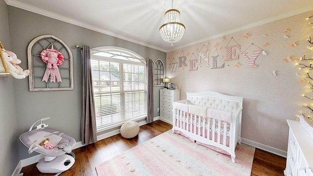 201 W Azalea Ln, Headland, AL 36345 - bedroom featuring a chandelier, dark wood-style floors, crown molding, and a crib