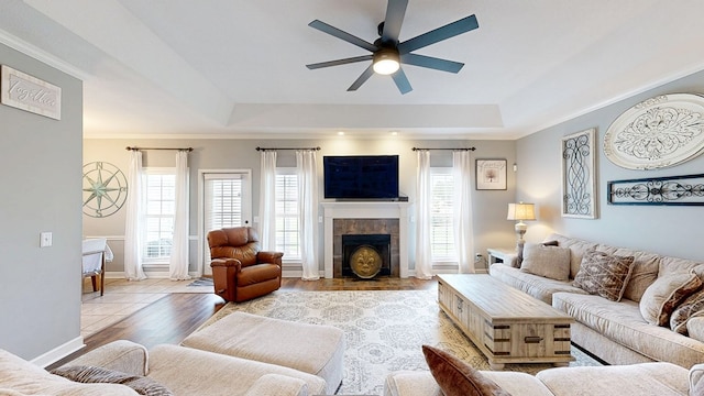 201 W Azalea Ln, Headland, AL 36345 - living area with a tray ceiling, a ceiling fan, a tiled fireplace, crown molding, and wood finished floors