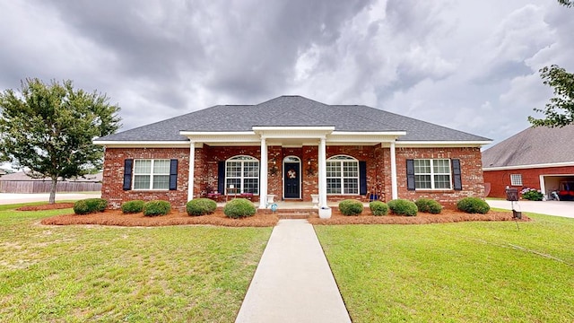 201 W Azalea Ln, Headland, AL 36345 - neoclassical home with a porch, a front yard, and brick siding