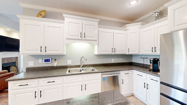 201 W Azalea Ln, Headland, AL 36345 - kitchen featuring stainless steel appliances, white cabinetry, ornamental molding, a fireplace, and recessed lighting
