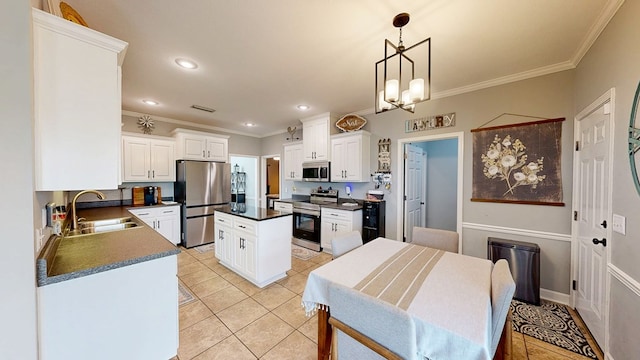 201 W Azalea Ln, Headland, AL 36345 - kitchen featuring stainless steel appliances, dark countertops, ornamental molding, white cabinets, and a kitchen island