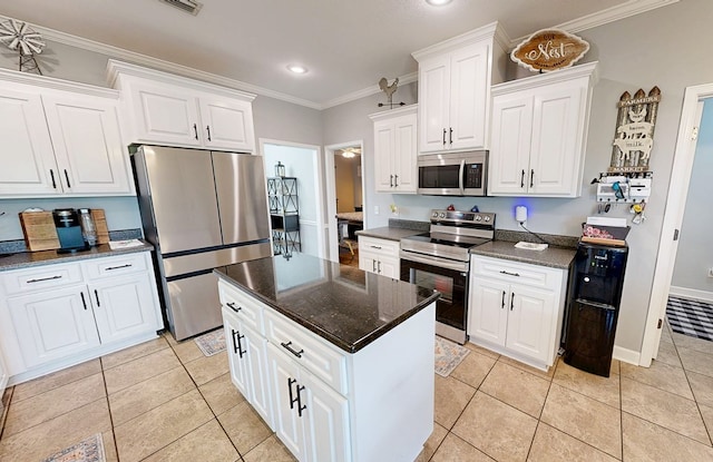 201 W Azalea Ln, Headland, AL 36345 - kitchen featuring stainless steel appliances, light tile patterned floors, white cabinets, ornamental molding, and a kitchen island
