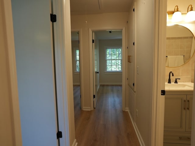 hallway featuring dark hardwood / wood-style flooring and sink