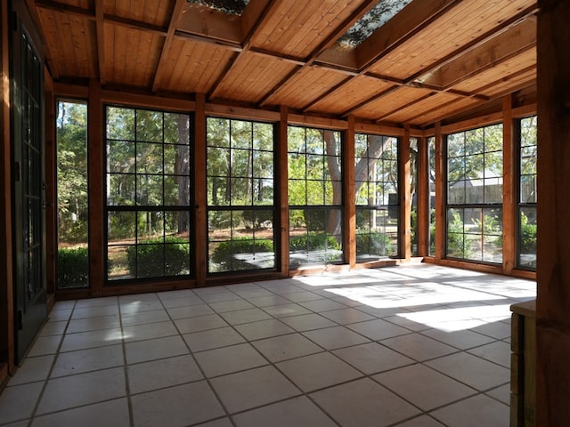 unfurnished sunroom featuring lofted ceiling and wooden ceiling