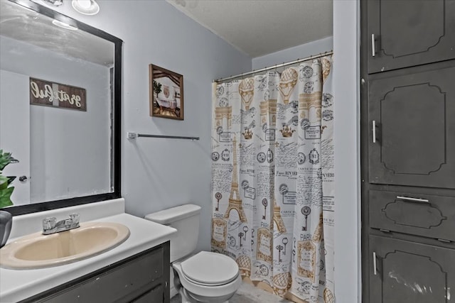 full bathroom with a shower with shower curtain, vanity, toilet, and a textured ceiling