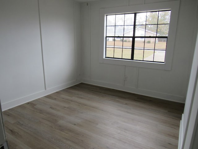 empty room with light hardwood / wood-style flooring