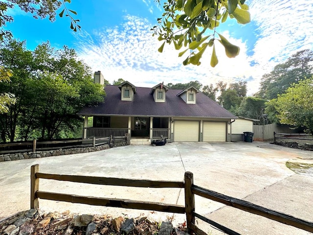 cape cod home with a porch and a garage