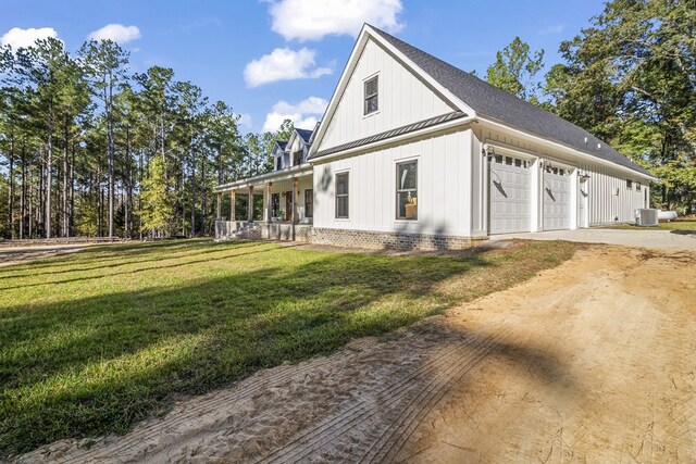 back of house with a lawn and covered porch