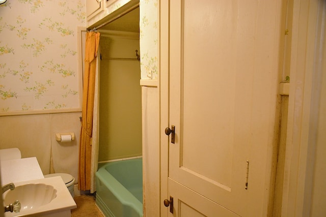 790 Claxton Ave, Elba, AL 36323 - full bathroom with wallpapered walls, toilet, a wainscoted wall, and a sink