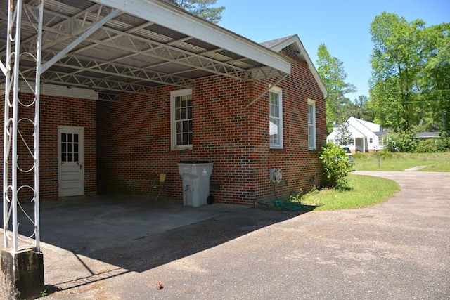 790 Claxton Ave, Elba, AL 36323 - view of property exterior featuring brick siding, driveway, and an attached carport