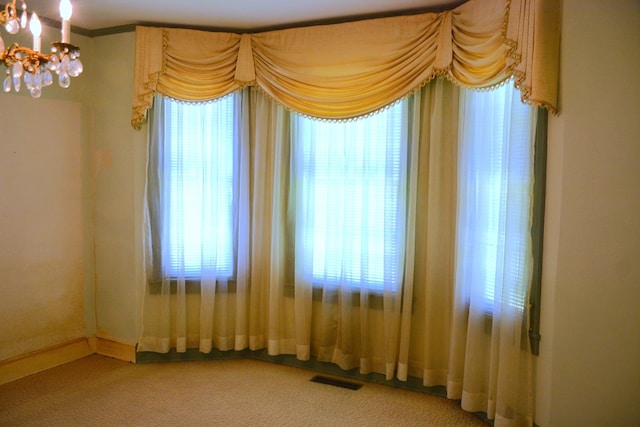 790 Claxton Ave, Elba, AL 36323 - spare room with baseboards, light carpet, a chandelier, and plenty of natural light
