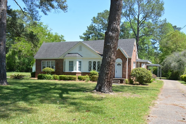 790 Claxton Ave, Elba, AL 36323 - view of front of house with a front lawn, brick siding, roof with shingles, and aphalt driveway