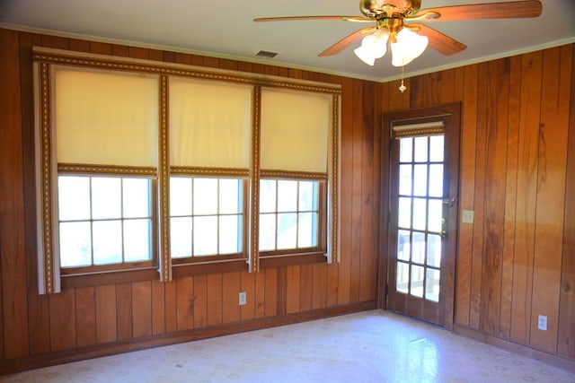 790 Claxton Ave, Elba, AL 36323 - empty room featuring baseboards, visible vents, a ceiling fan, light floors, and wooden walls