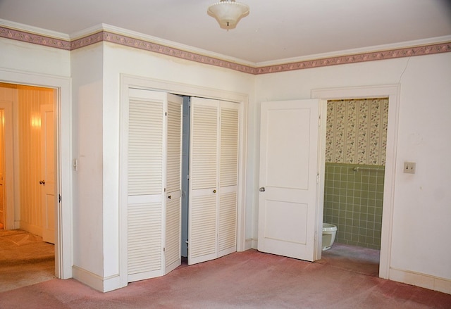 790 Claxton Ave, Elba, AL 36323 - unfurnished bedroom featuring connected bathroom, a closet, crown molding, and carpet
