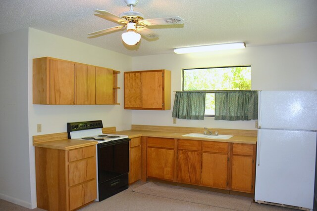 790 Claxton Ave, Elba, AL 36323 - kitchen with a sink, electric range, freestanding refrigerator, a ceiling fan, and light countertops