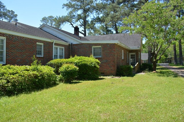 790 Claxton Ave, Elba, AL 36323 - view of home's exterior featuring a chimney, brick siding, a yard, and crawl space