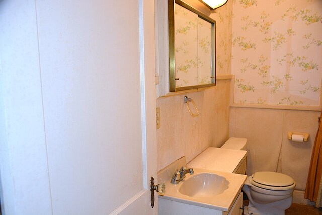 790 Claxton Ave, Elba, AL 36323 - bathroom featuring wallpapered walls, a wainscoted wall, vanity, and toilet