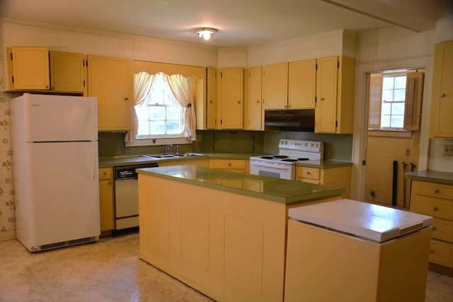 790 Claxton Ave, Elba, AL 36323 - kitchen featuring under cabinet range hood, a healthy amount of sunlight, a sink, white appliances, and a center island