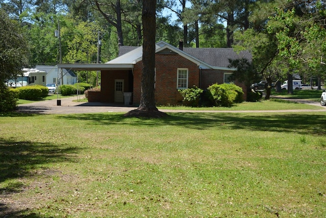 790 Claxton Ave, Elba, AL 36323 - view of home's exterior featuring brick siding, a yard, and a carport