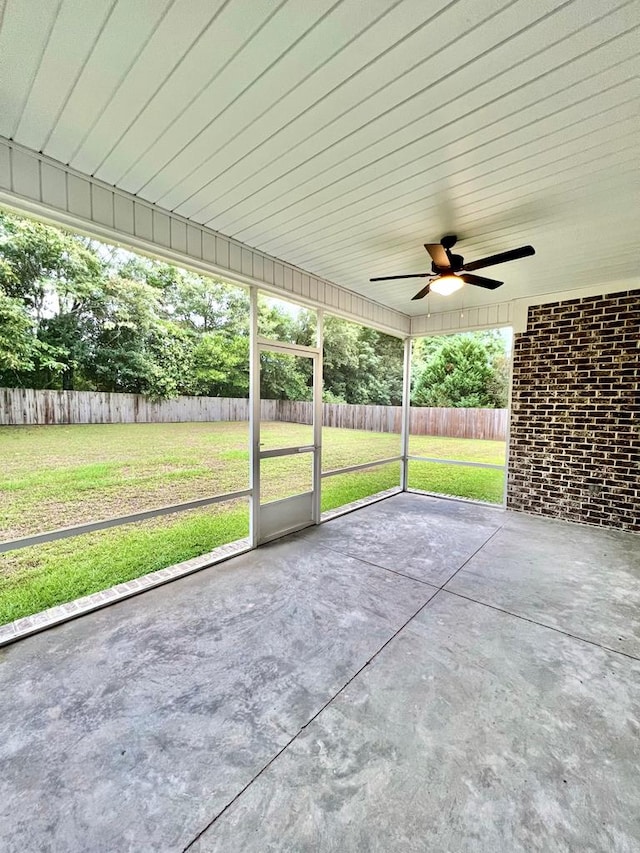 unfurnished sunroom featuring a wealth of natural light and ceiling fan