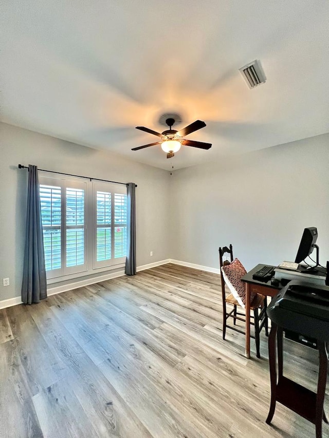 office space with ceiling fan and light wood-type flooring