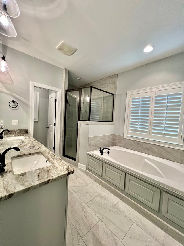 bathroom featuring vanity and shower with separate bathtub