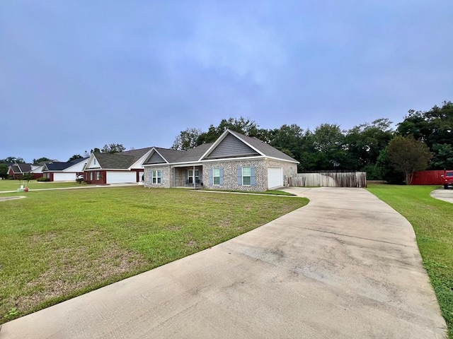 view of front of property featuring a front yard and a garage