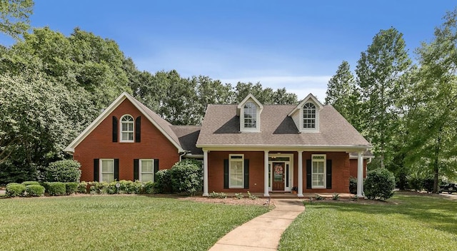 400 Bent Oak Dr, Dothan, AL 36303 - cape cod-style house with covered porch, a front yard, and brick siding