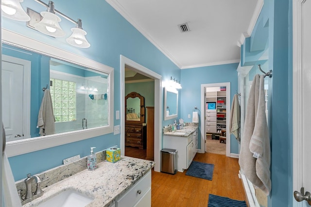 400 Bent Oak Dr, Dothan, AL 36303 - bathroom featuring a shower stall, ornamental molding, wood finished floors, a spacious closet, and vanity