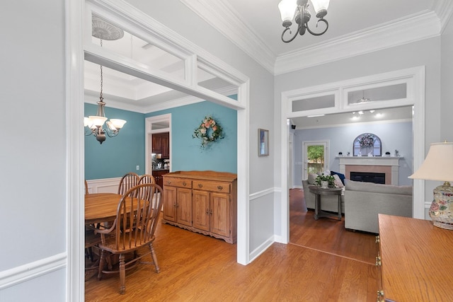 400 Bent Oak Dr, Dothan, AL 36303 - dining space featuring a chandelier, crown molding, light wood-style floors, and a fireplace
