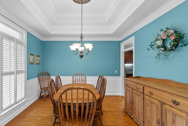 400 Bent Oak Dr, Dothan, AL 36303 - dining room featuring a raised ceiling, a chandelier, light wood finished floors, wainscoting, and crown molding