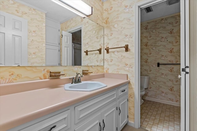 bathroom with tile patterned flooring, vanity, and toilet