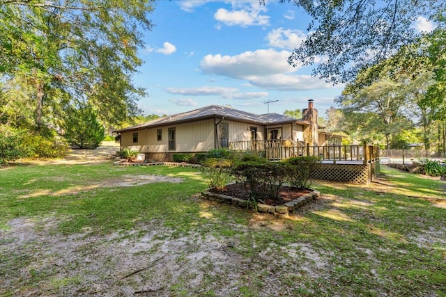 view of property exterior with a lawn and a deck