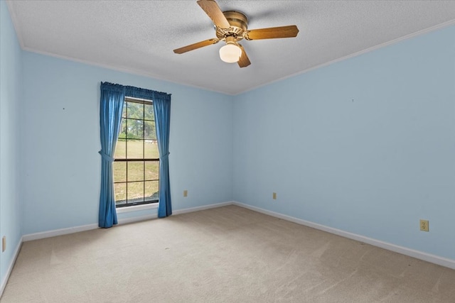 unfurnished room featuring ceiling fan, light colored carpet, ornamental molding, and a textured ceiling