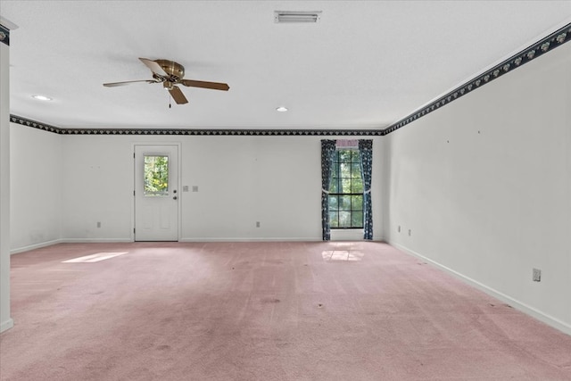 spare room featuring a textured ceiling, light colored carpet, and ceiling fan