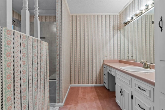 bathroom featuring a tile shower, crown molding, vanity, and a textured ceiling