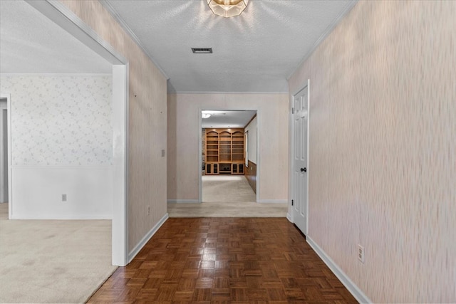 hall with dark parquet flooring and a textured ceiling