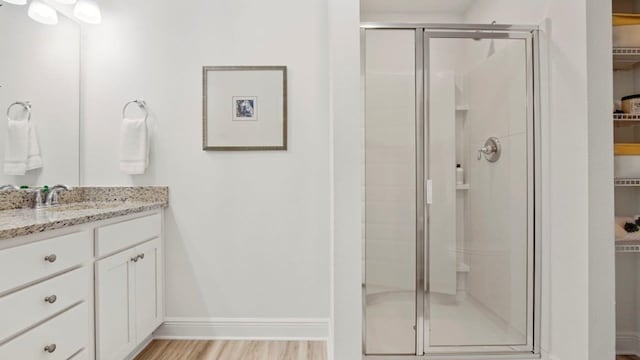 267 Fawnfield Ln, Dothan, AL 36301 - bathroom with a shower stall, a walk in closet, vanity, and baseboards