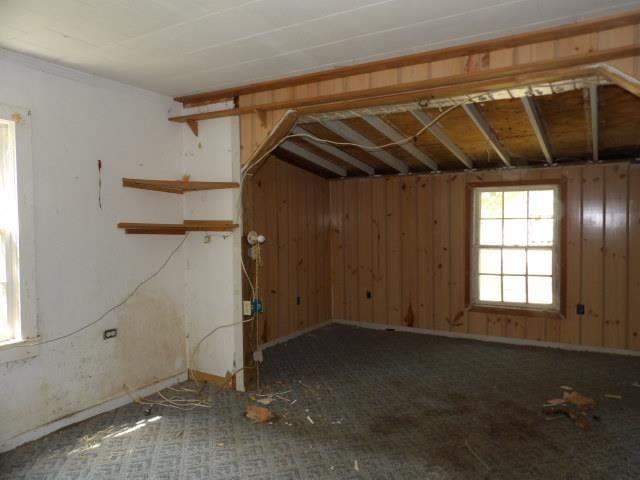 empty room featuring wooden walls