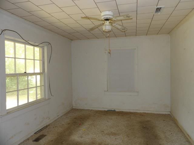 unfurnished room with ceiling fan and plenty of natural light