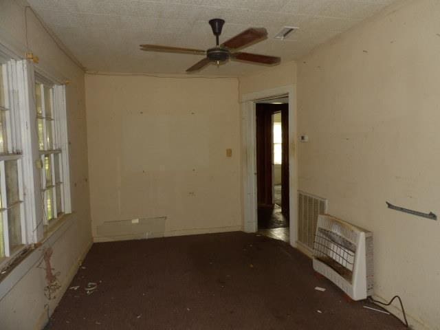 spare room with ceiling fan and heating unit