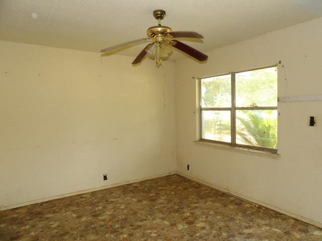 empty room featuring ceiling fan