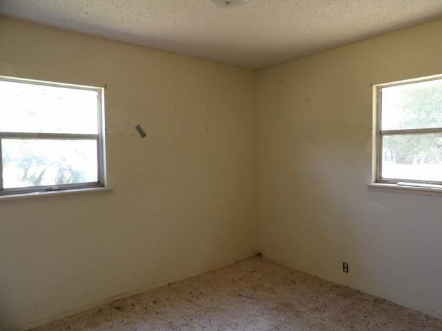 spare room featuring a textured ceiling