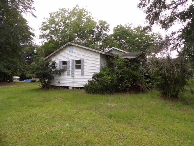 view of home's exterior with a yard