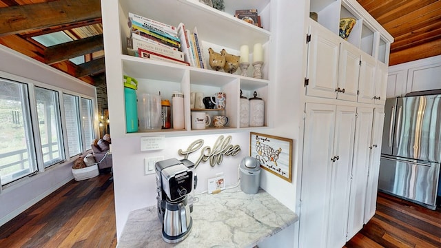 8875 E State Highway 52, Webb, AL 36376 - detailed view of freestanding refrigerator, open shelves, white cabinetry, dark wood-style flooring, and wood ceiling