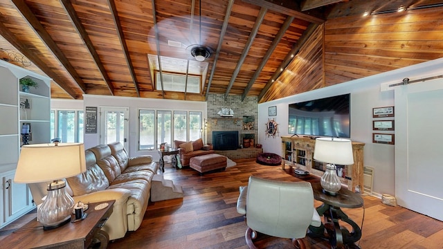 8875 E State Highway 52, Webb, AL 36376 - living room with wood ceiling with exposed beams, wood finished floors, a brick fireplace, a barn door, and high vaulted ceiling