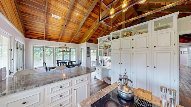 8875 E State Highway 52, Webb, AL 36376 - kitchen with open shelves, dark wood finished floors, wood ceiling with exposed beams, white cabinetry, and stone counters