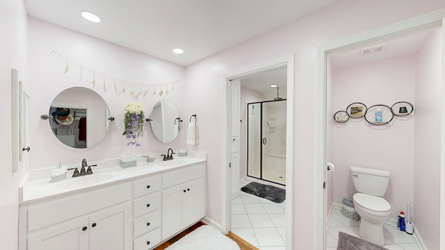 8875 E State Highway 52, Webb, AL 36376 - bathroom featuring a shower stall, toilet, double vanity, tile patterned floors, and baseboards