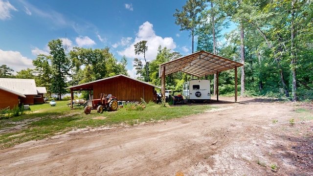 8875 E State Highway 52, Webb, AL 36376 - exterior space featuring a carport, dirt driveway, and an outdoor structure