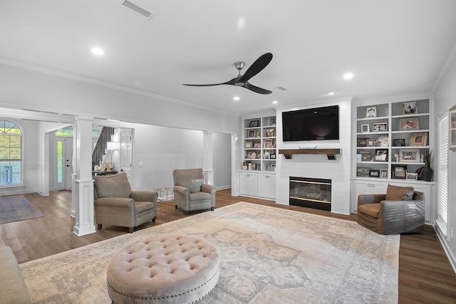 856 S County Rd 49, Dothan, AL 36301 - living room with ornate columns, ceiling fan, wood finished floors, a fireplace, and crown molding